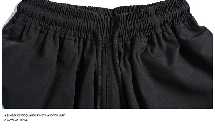 Loose fit quick-drying sports shorts in black, featuring an elastic waistband and straight-leg design.