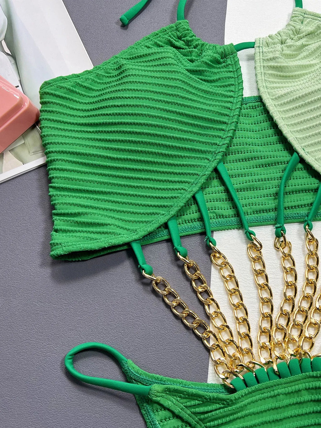 Green women's one-piece swimsuit with a hollow cut-out design detail on the front.