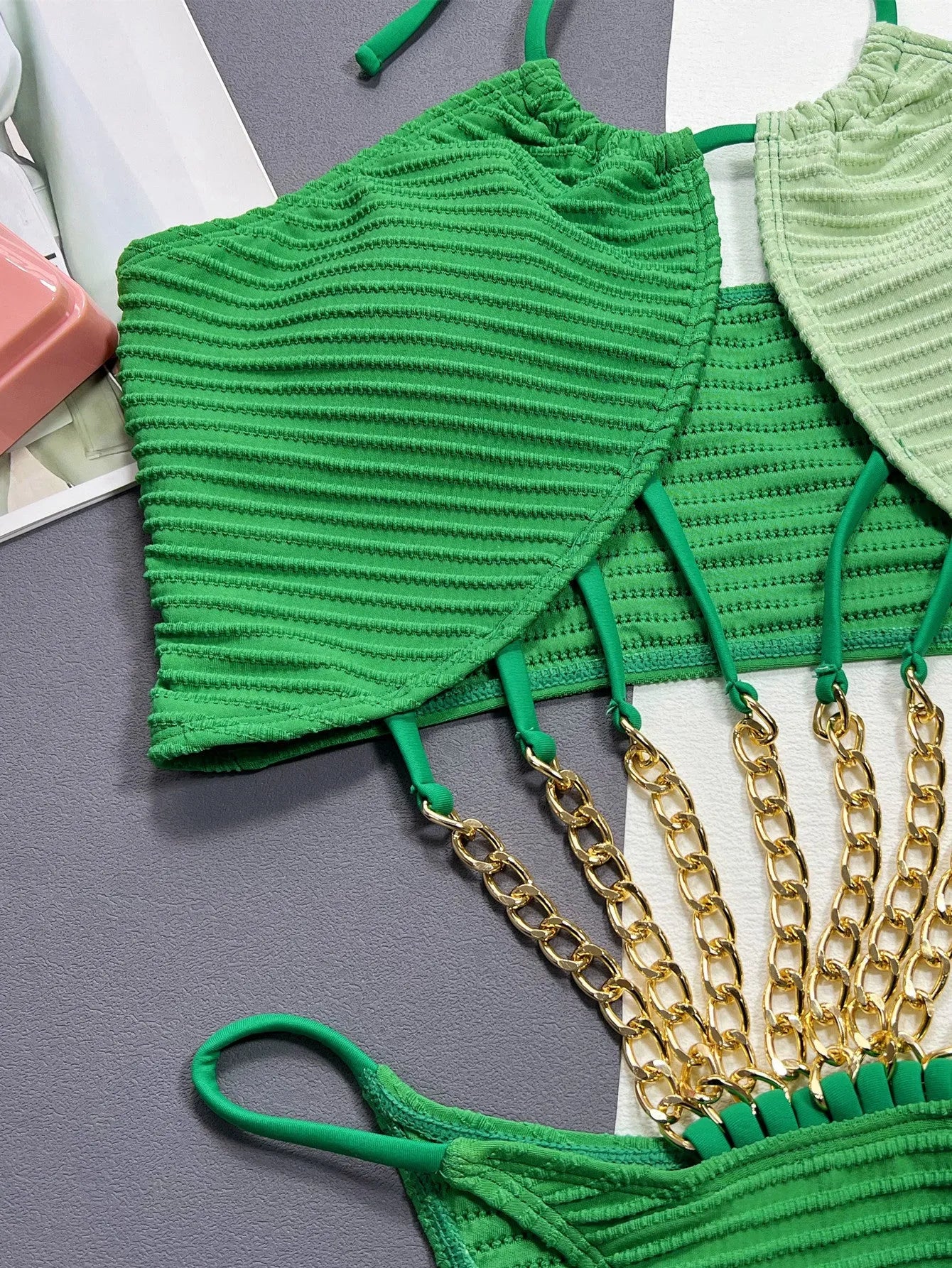 Green women's one-piece swimsuit with a hollow cut-out design detail on the front.