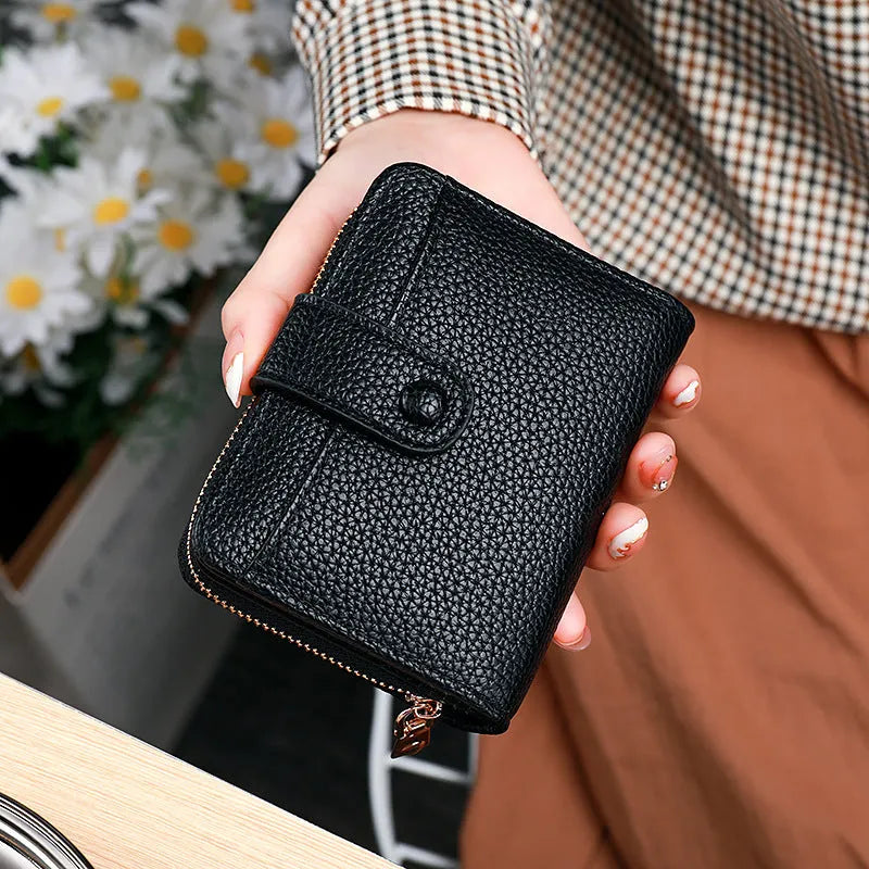 Women's lychee pattern organ short wallet in pu leather available in beige pink black and red colours
