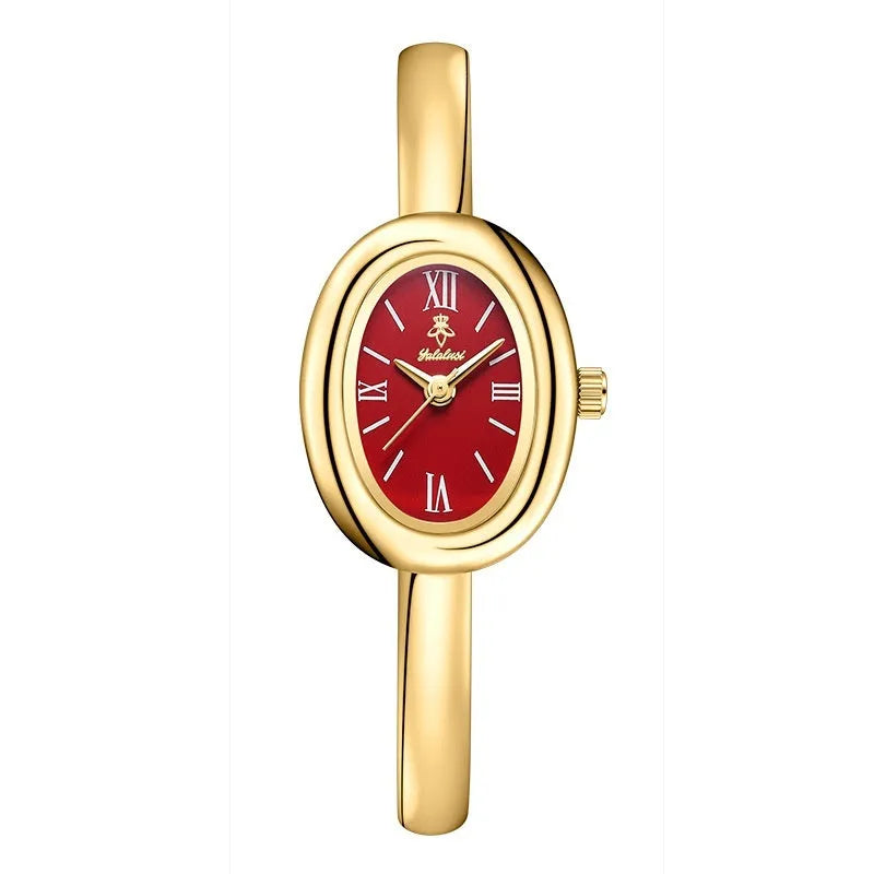Women's retro oval quartz watch in gold colour with spiral pattern design on wrist