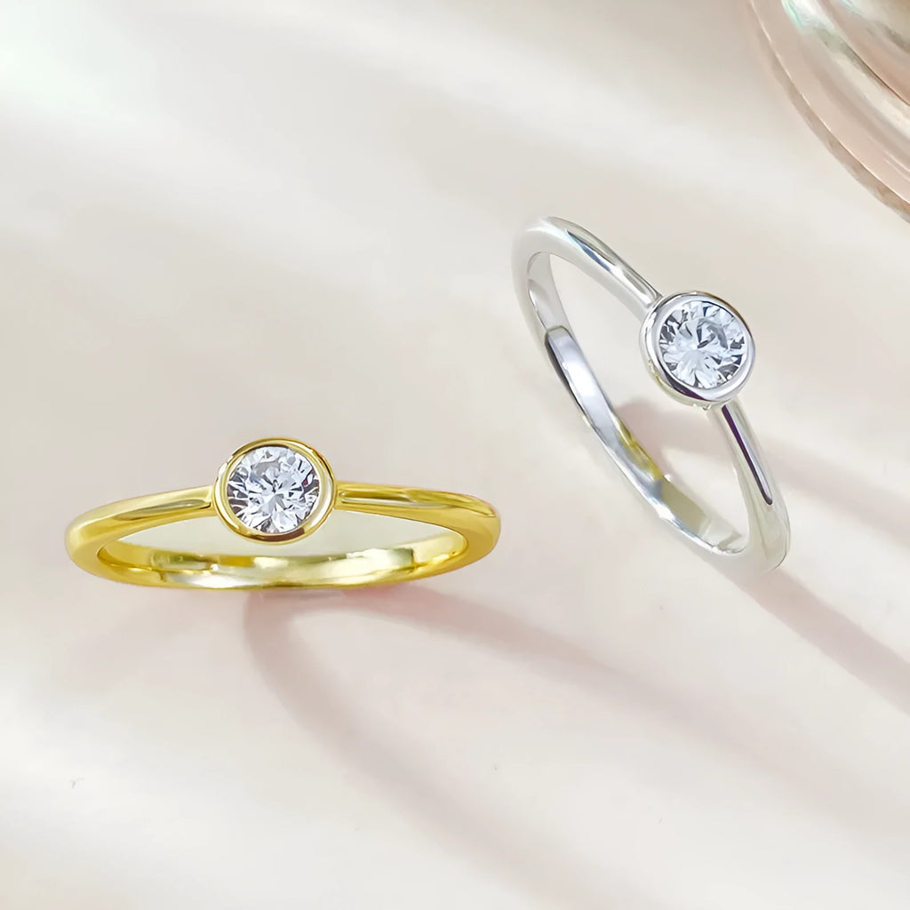 Minimalist silver crown-shaped ring with linear design, shown in electroplated gold and platinum finishes.