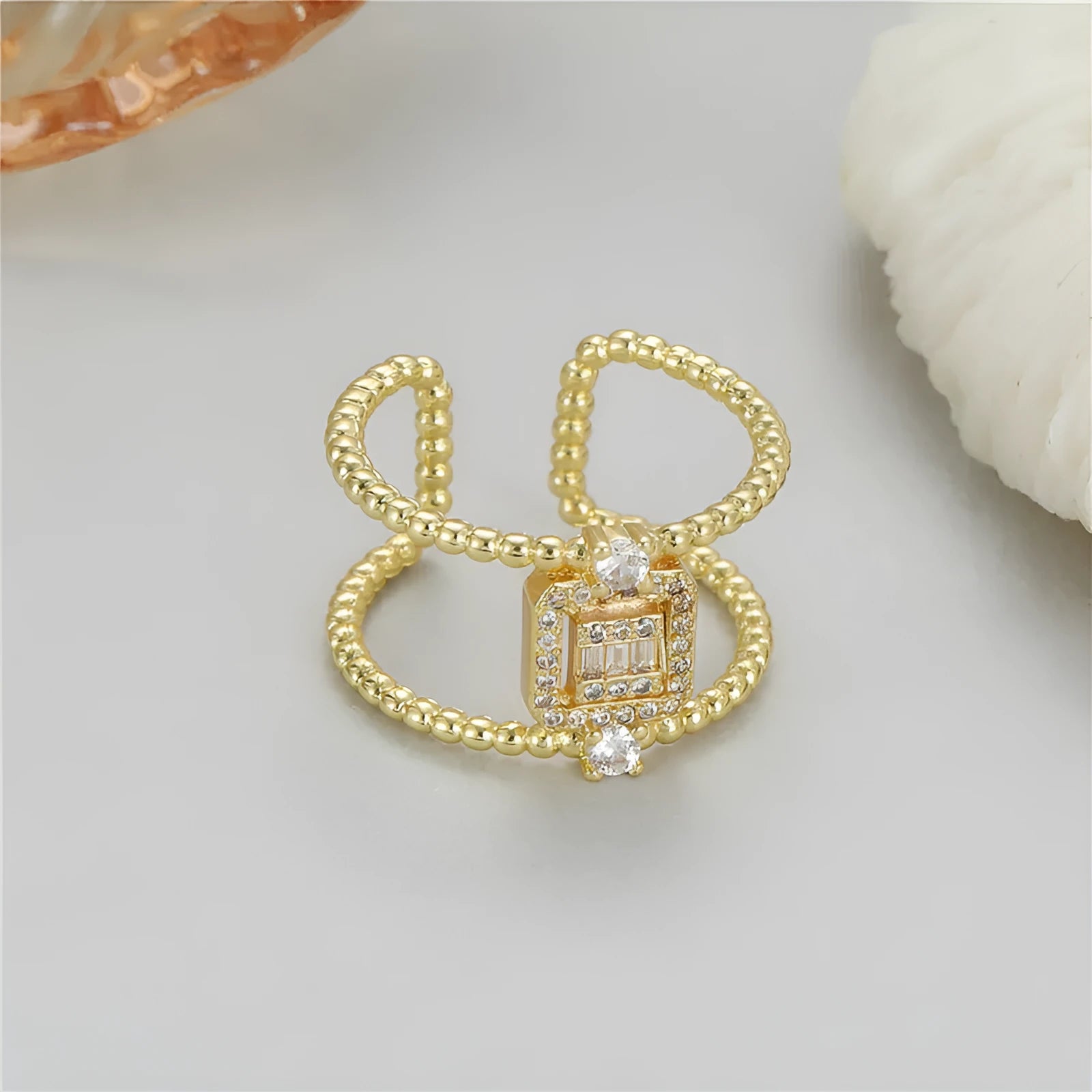 Adjustable open ring with 14K copper-plated gold finish and asymmetric U-shaped design