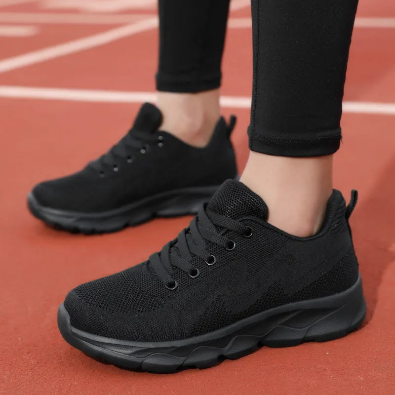 Women's lightweight mesh breathable running shoes with wedge heel in black upper side view