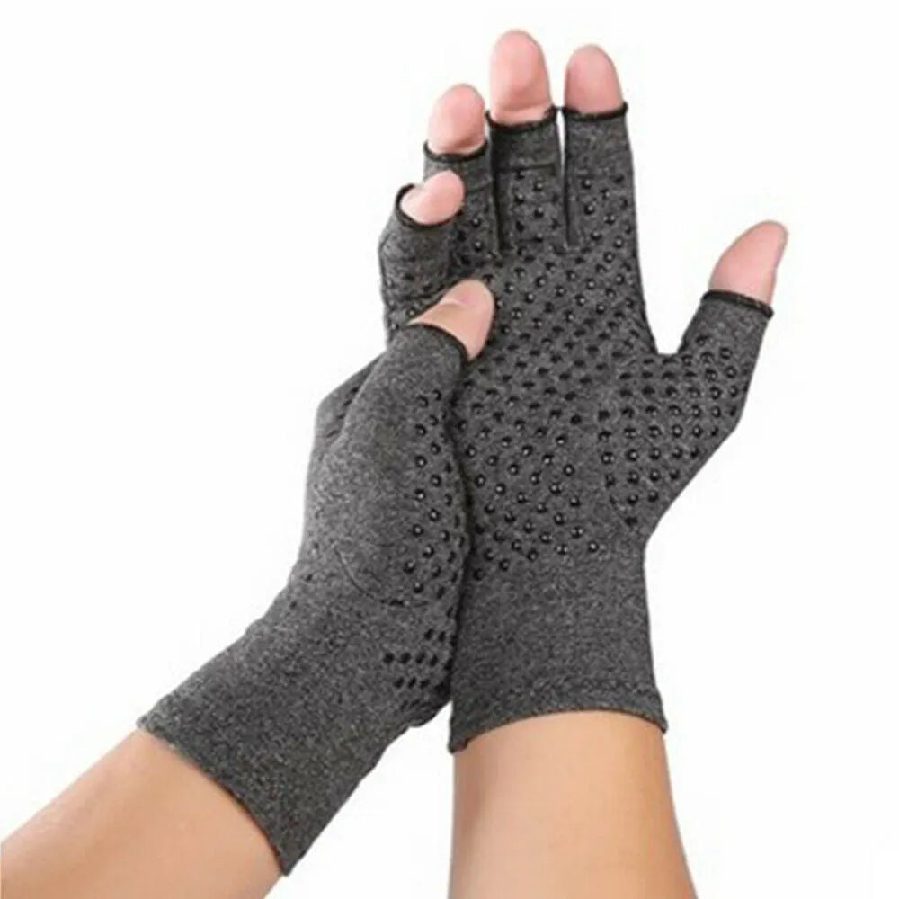 Grey half finger joint compression gloves with anti-slip texture on a flat surface.