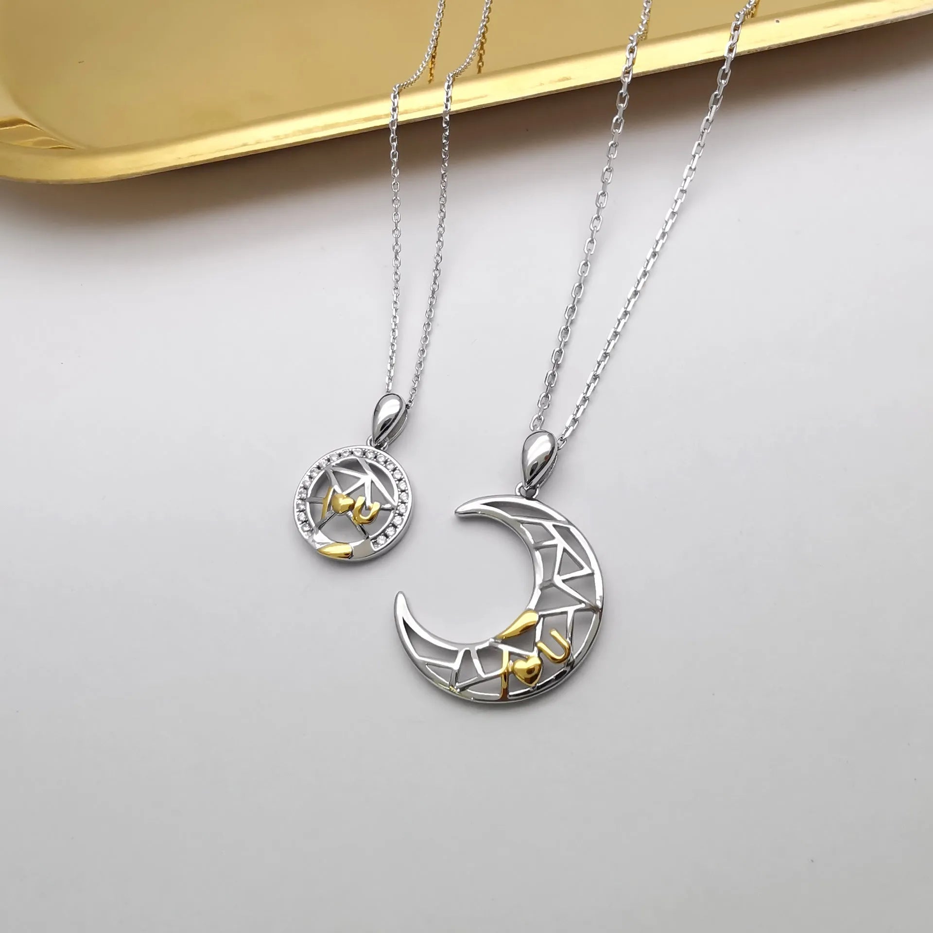 Sun and moon couple necklace with copper pendant on cross chain, showing male and female colour options