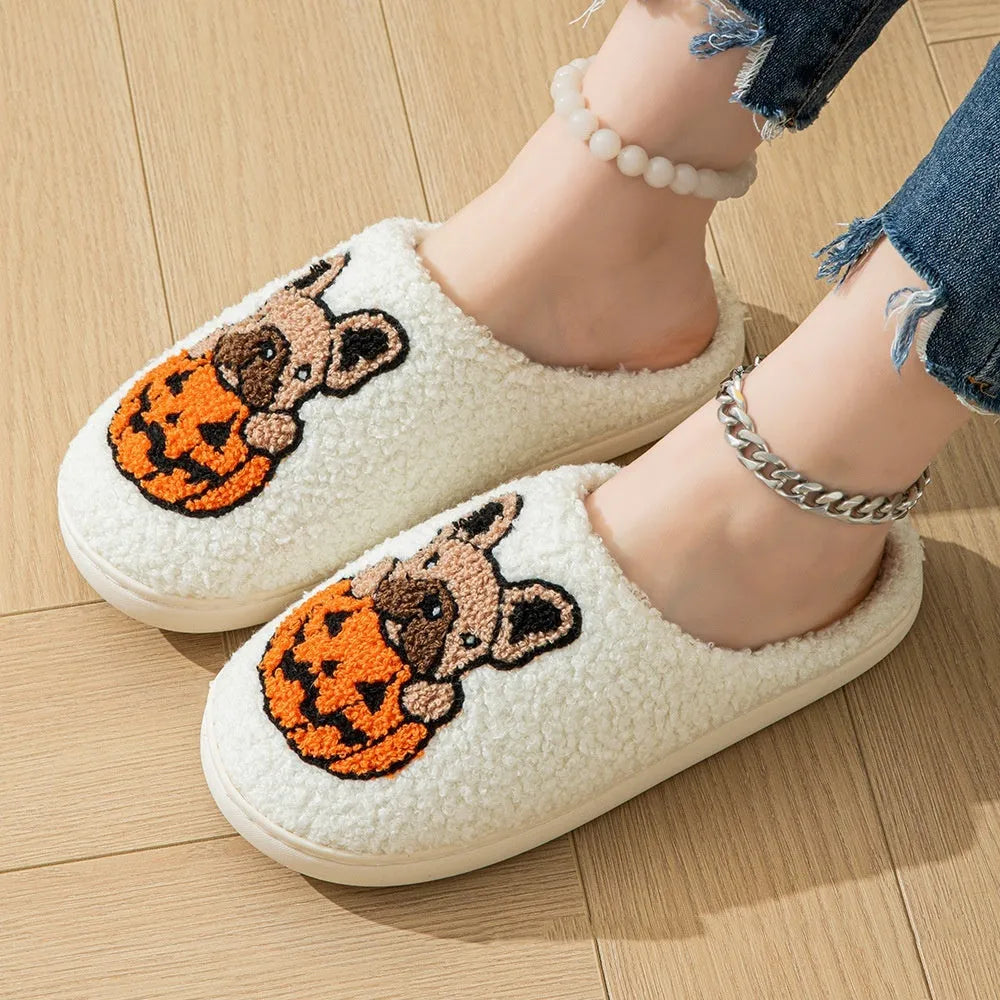 Black and white Halloween slippers with pumpkin design, plush upper, and textured TPR non-slip sole.