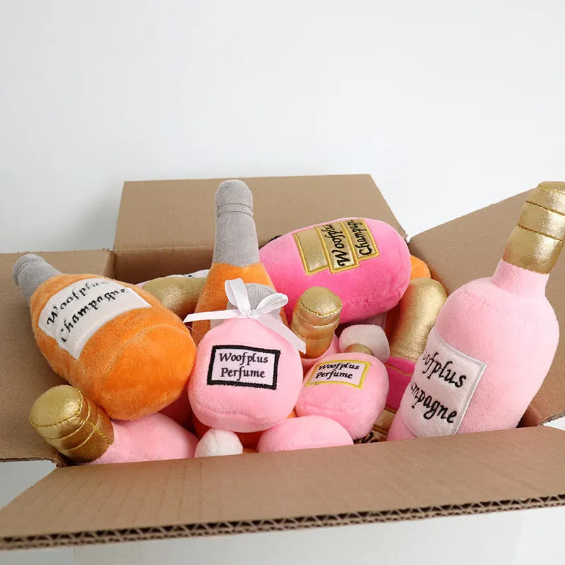 Soft green plush wine bottle pet toy for dogs and cats on a white background.