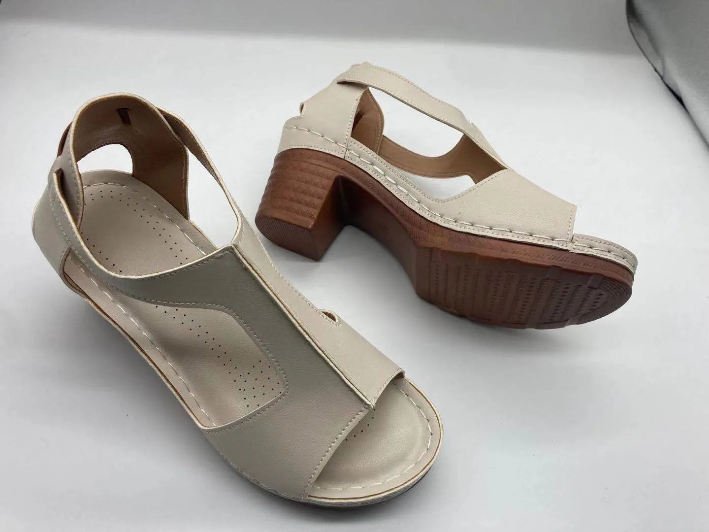 Peep toe wedge sandals with Roman style buckle and fish mouth open toe design in creamy-white colour
