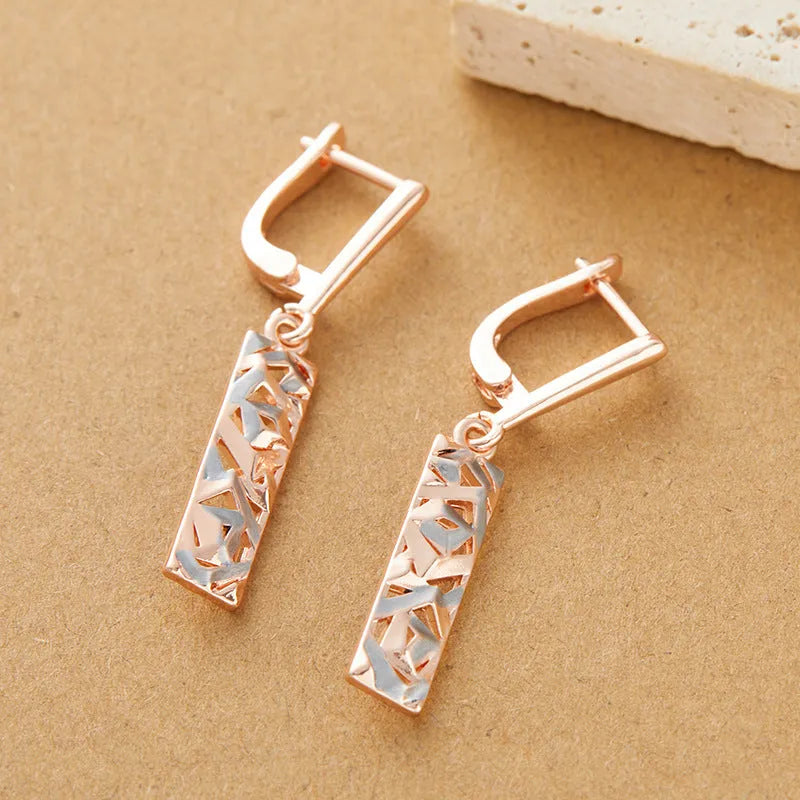A pair of rectangular two-tone hollow stud earrings with a geometric shape and electroplated finish.
