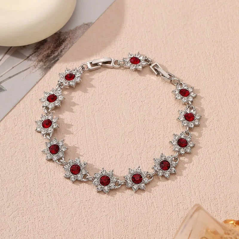 Electroplated zinc alloy flower bracelet with coloured gems in gold and silver colour options