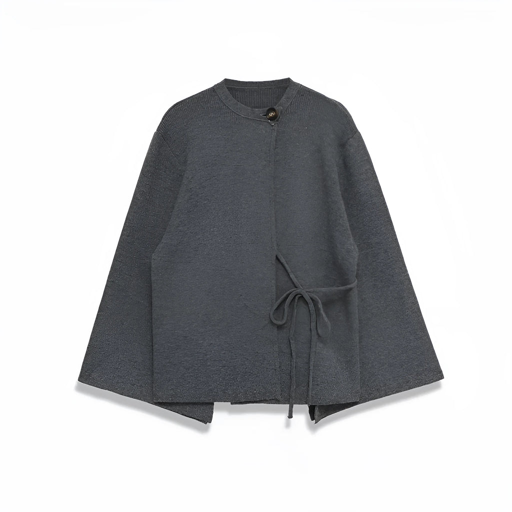 Women's long gray knitted coat with slit sleeves and pockets on display