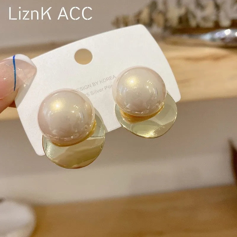 Alloy round stud earrings for women, casual style with metal finish, side view on model