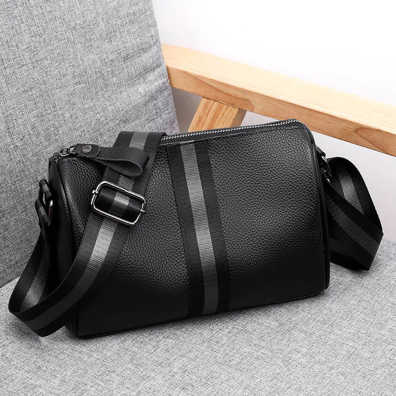 Black genuine leather one-shoulder crossbody bag showing its size and style.
