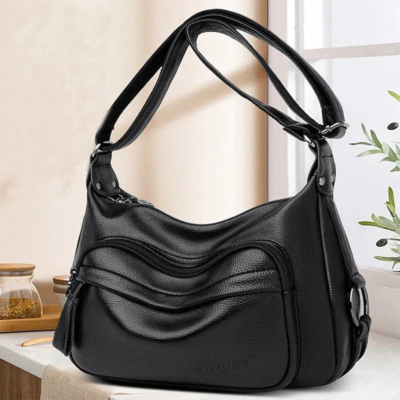 Women's blue crossbody shoulder bag with multiple interior pockets and zip closure