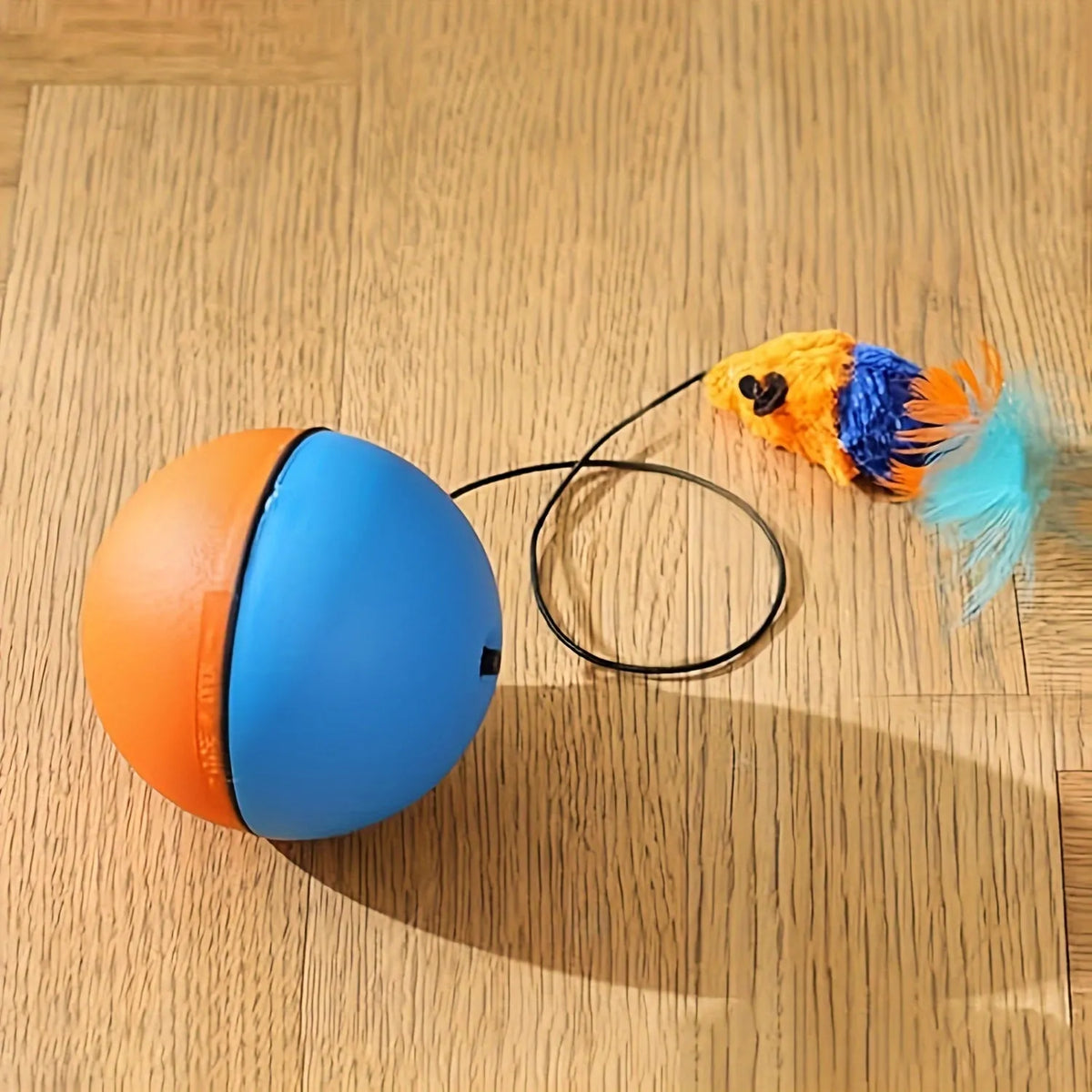 Interactive cat toy ball with plush mouse attachment in grey or orange colour