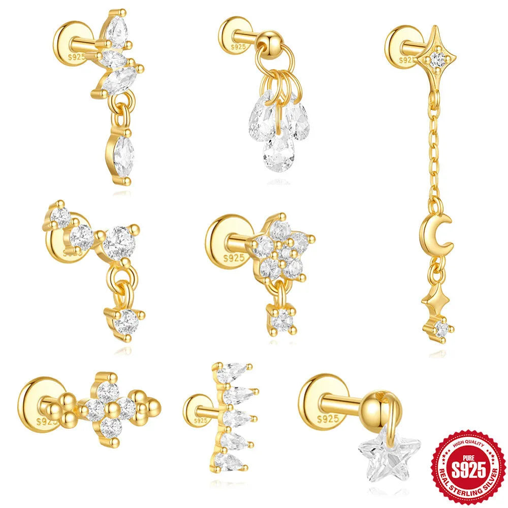 S925 sterling silver moon and star earrings with embedded diamonds on a gold tone background.