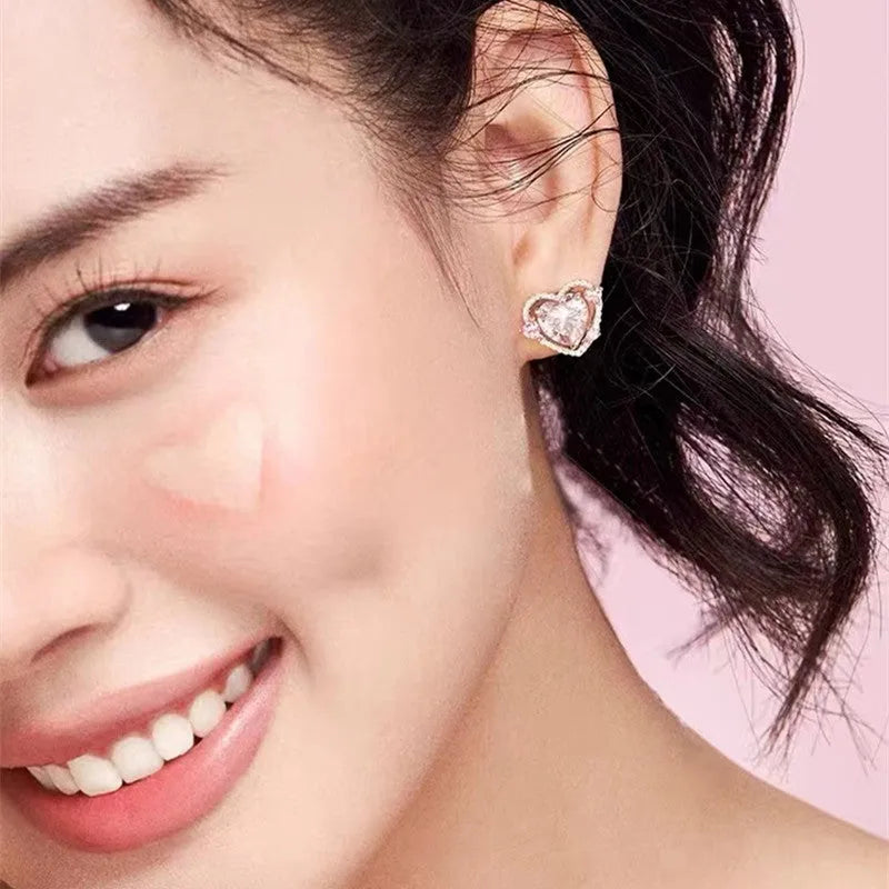 A pair of heart-shaped stud earrings with a white gold colour finish.