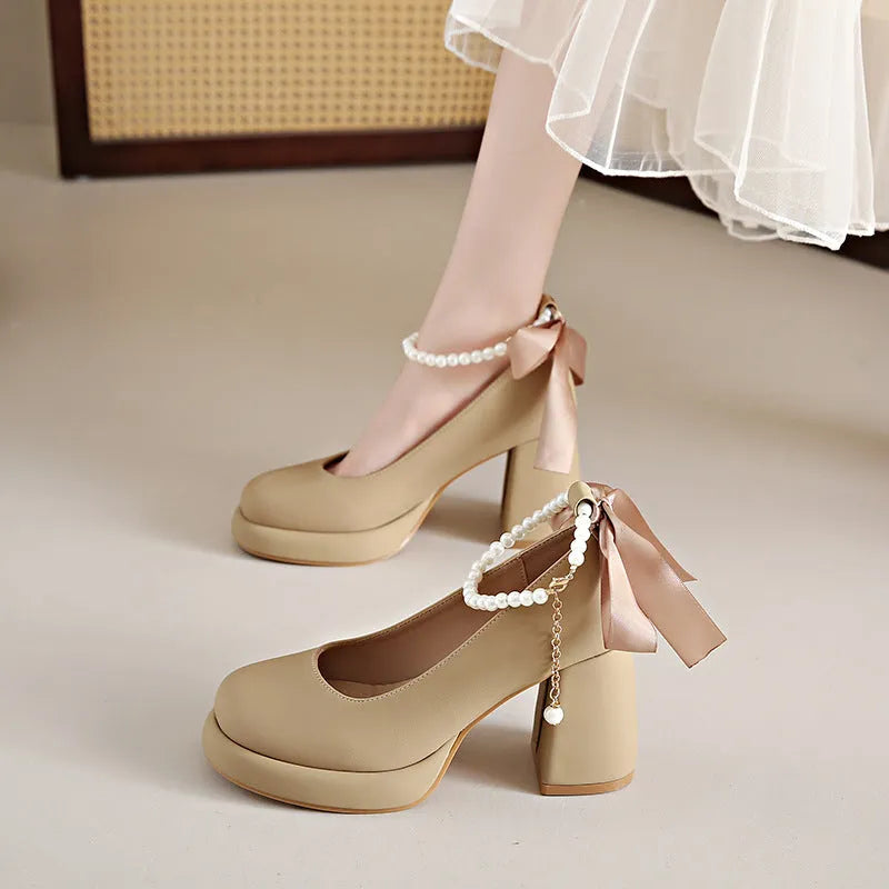 Women's beige Mary Jane shoes with ankle strap buckle, chunky low heel, pearl detail and round toe.