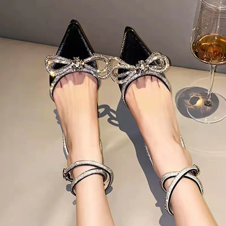 Women's black stiletto heel sandals with a silk bandage across the back and a buckle strap.