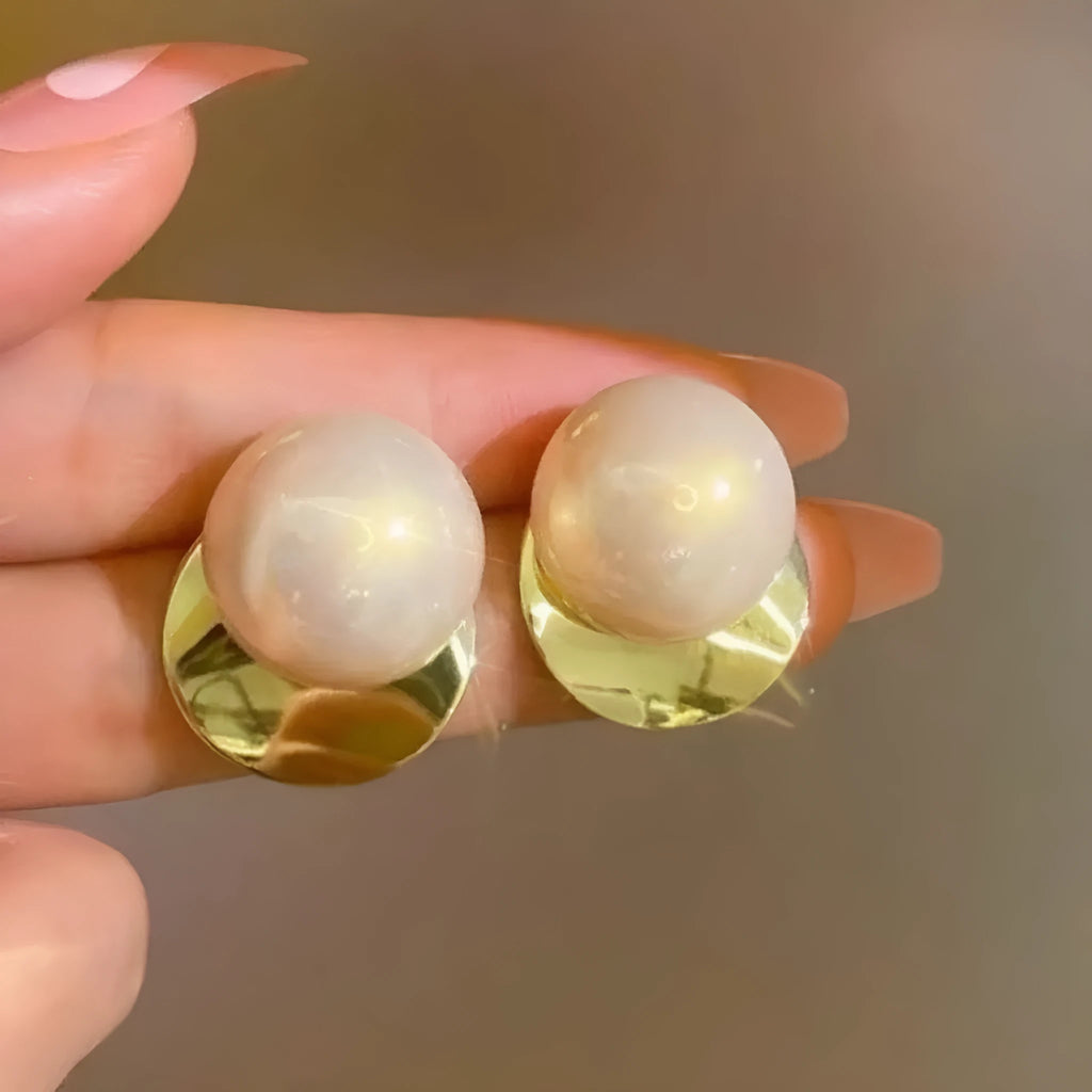 Alloy round stud earrings for women, casual style with metal finish, side view on model