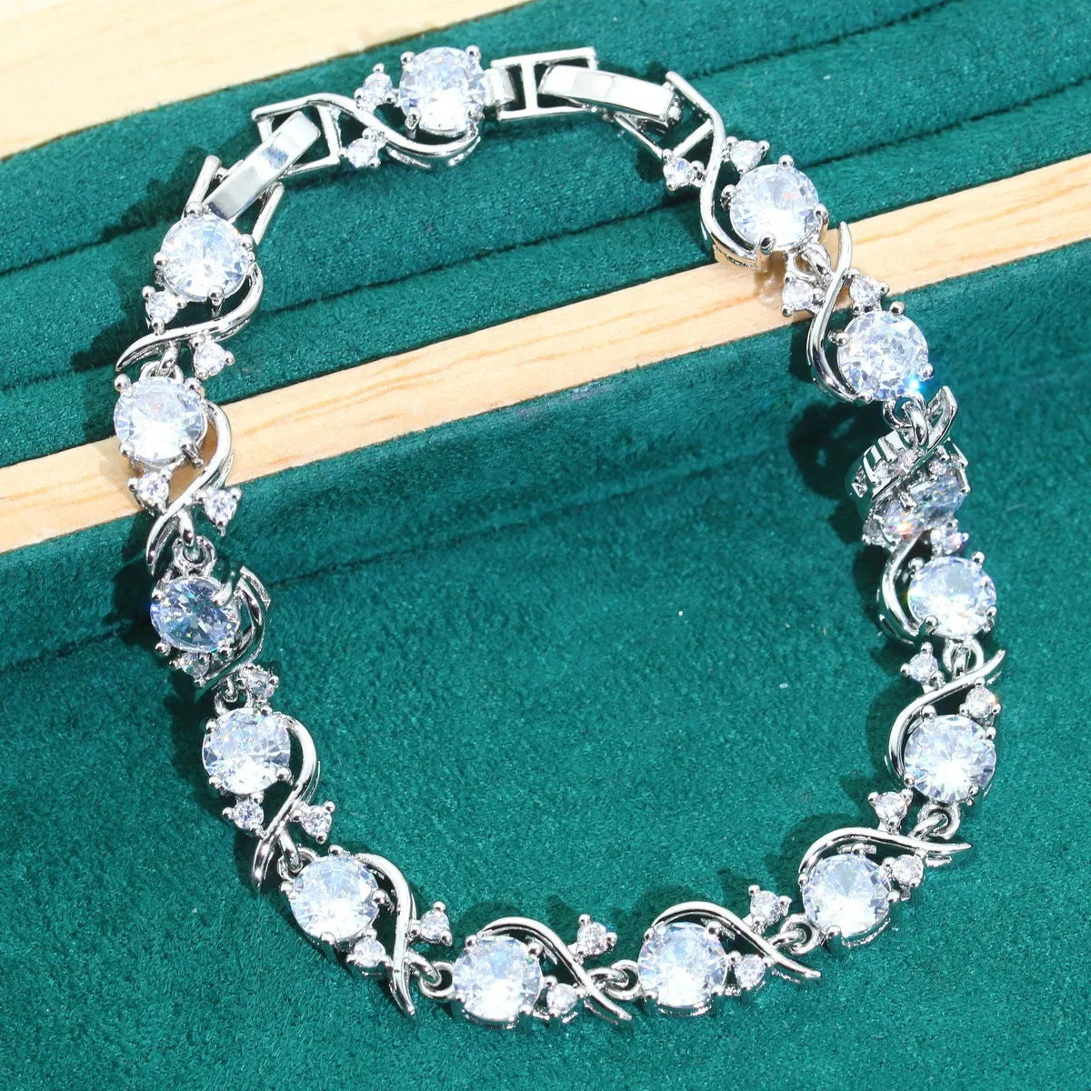 Bridal zircon necklace, bracelet, earrings, and ring four-piece jewellery set in alloy with water wave chain design.