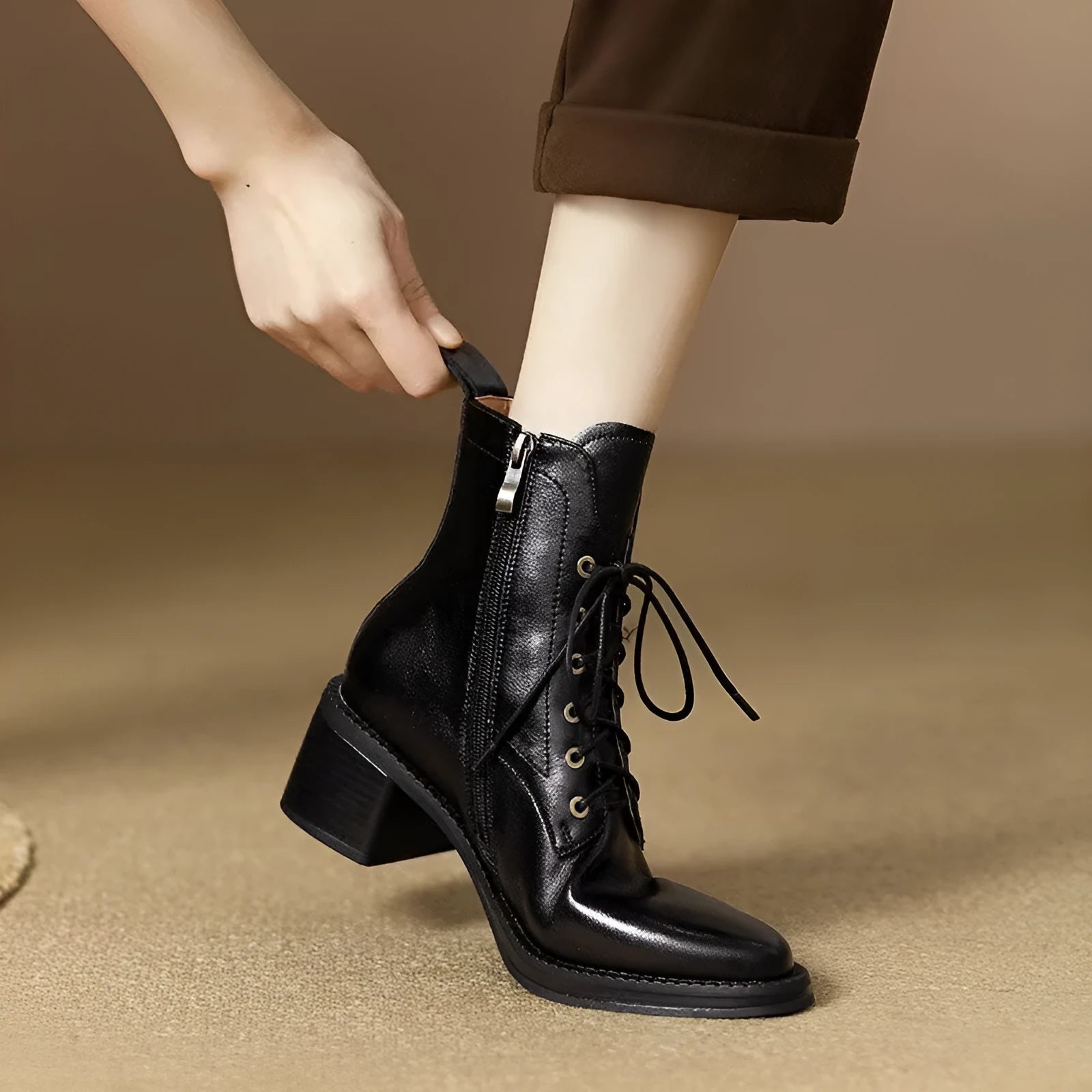 Women's black and brown pointed-toe ankle boots with a 5.5cm heel on a plain background