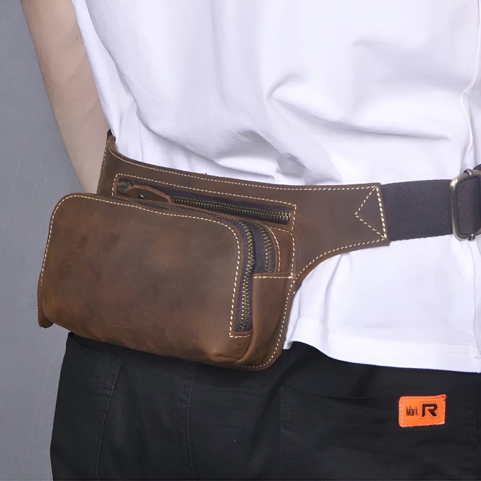 Brown cow leather men's sports waist bag with pull closure showing internal phone compartment