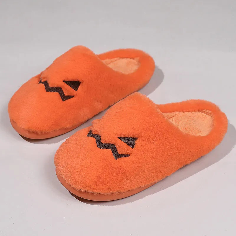 Orange Halloween pumpkin design slippers with plush lining and a textured PVC sole.