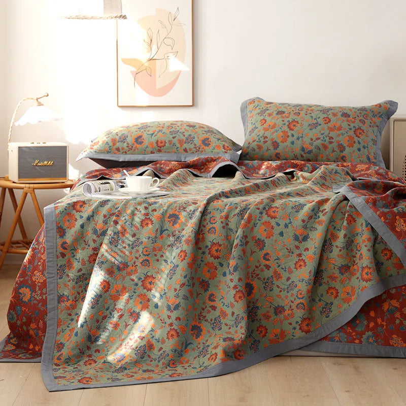 Cotton gauze bedding three-piece set showing botanical flower pattern on blanket and matching pillowcases