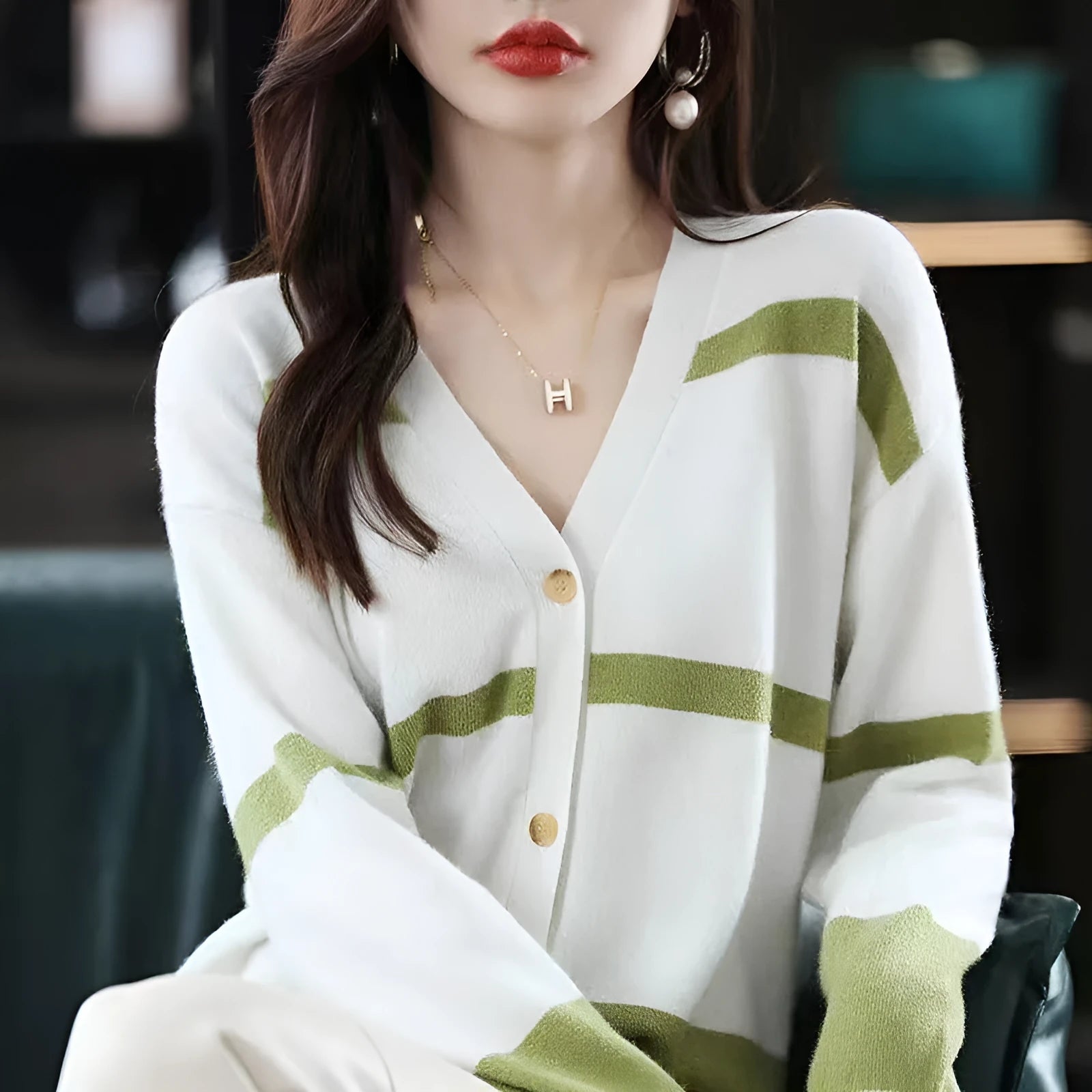 Women's black and white striped knitted cardigan with 3D pattern, V-neck, and button-up front.