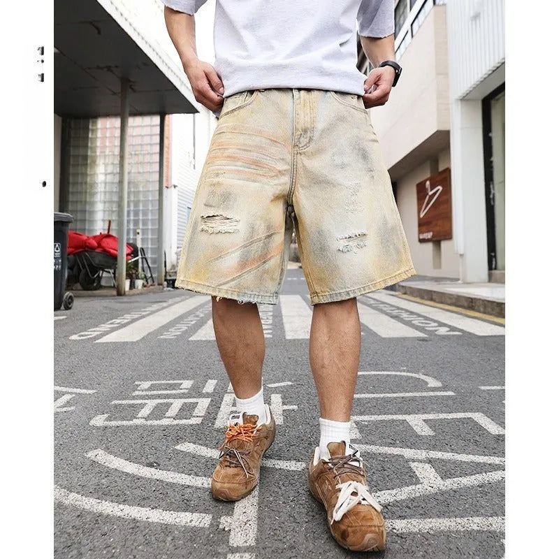 Men's light blue ripped denim shorts showing straight-leg design and mid waist fit