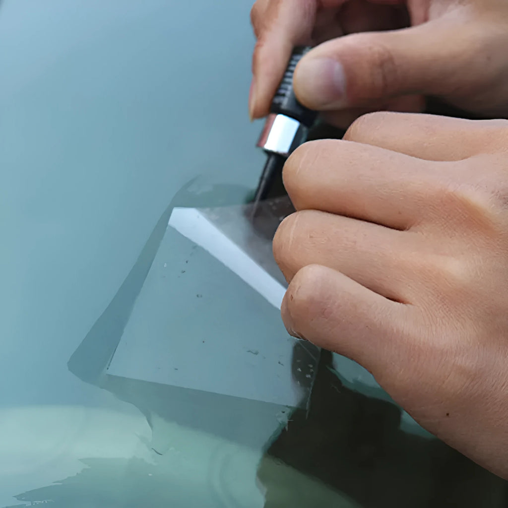 Yellow three-piece car windscreen repair kit with glass repair liquid and application tools