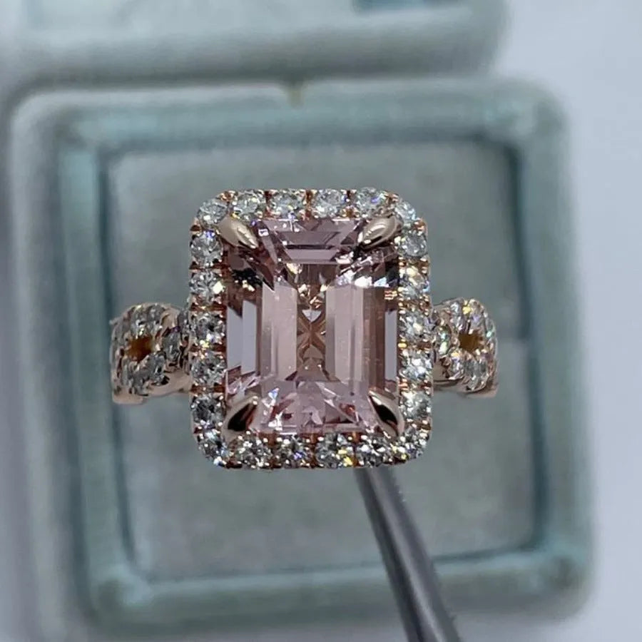 Rose gold geometric alloy ring on a plain background, showing its electroplated finish.