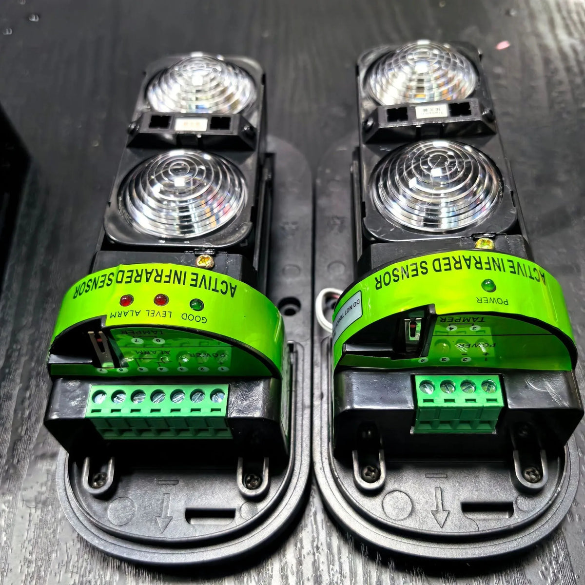 A pair of black infrared detector units for a wired anti-theft alarm system with a 150-metre range.