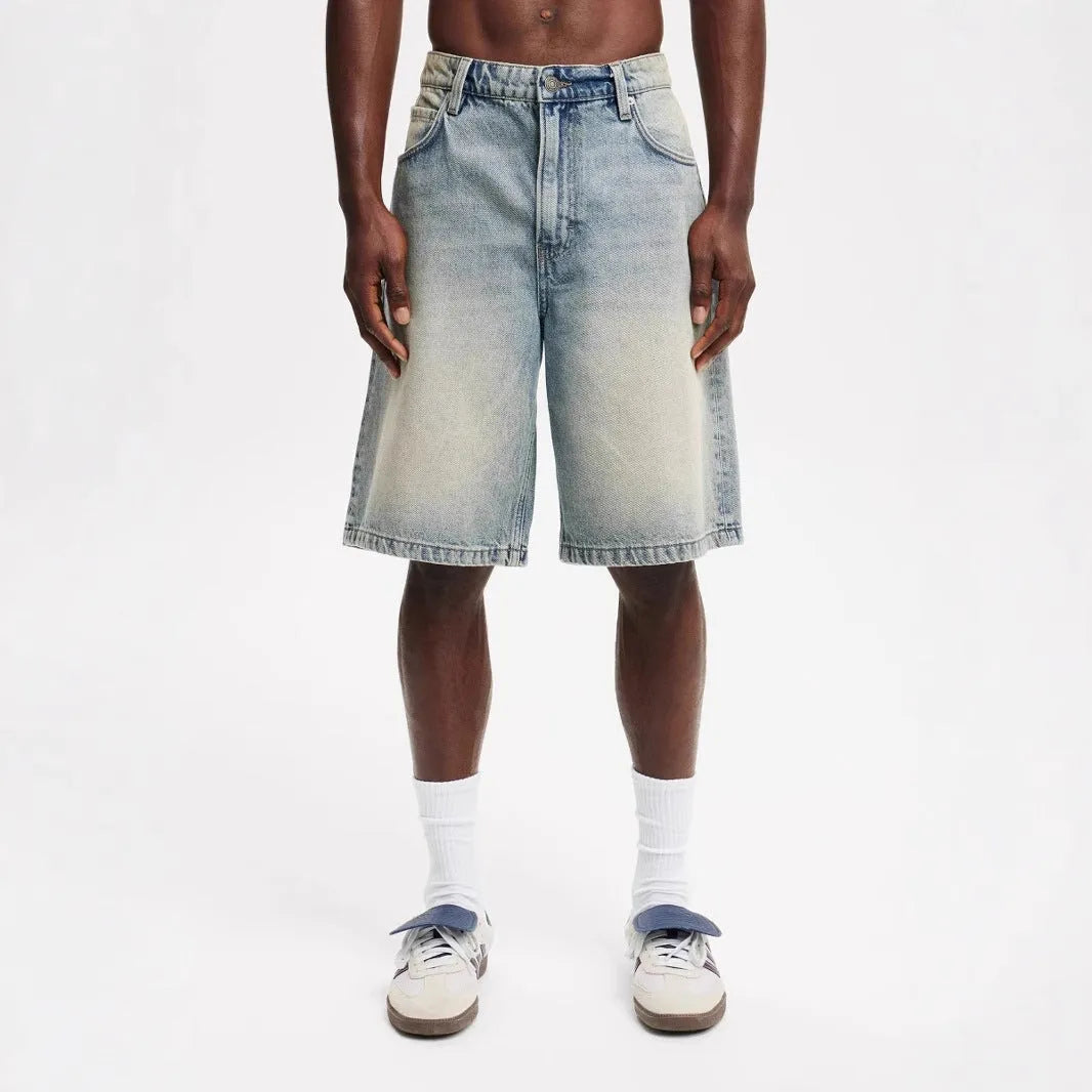 Men's loose straight-leg light blue denim jeans on a white background