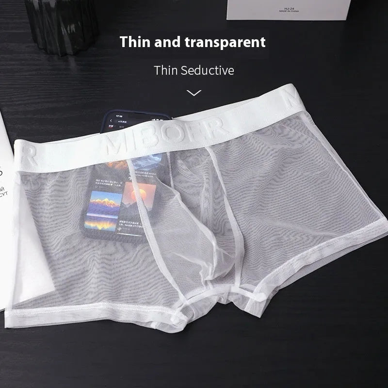Men's thin solid colour boxer shorts in black, white, blue, green, pink, and skin colour on a white background.