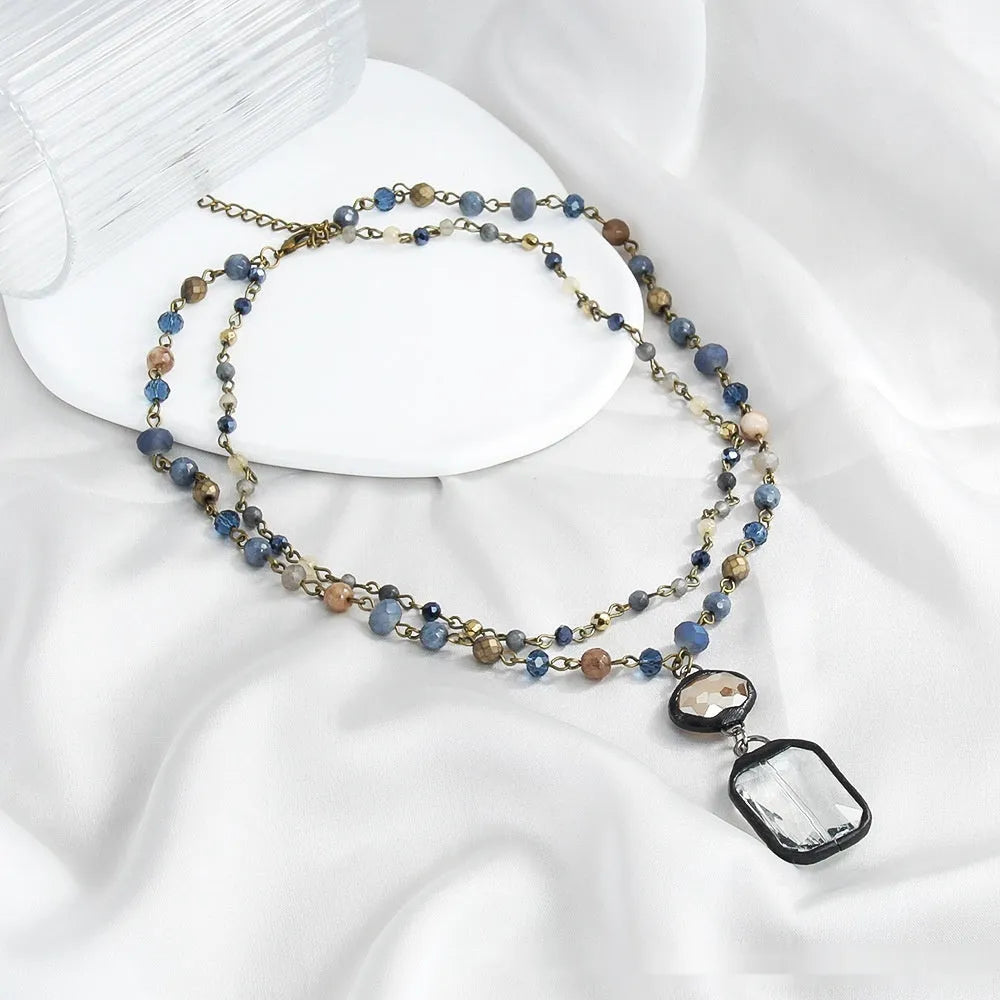 Tribal style two-layer necklace with glass and semi-precious stone pendant on adjustable chain