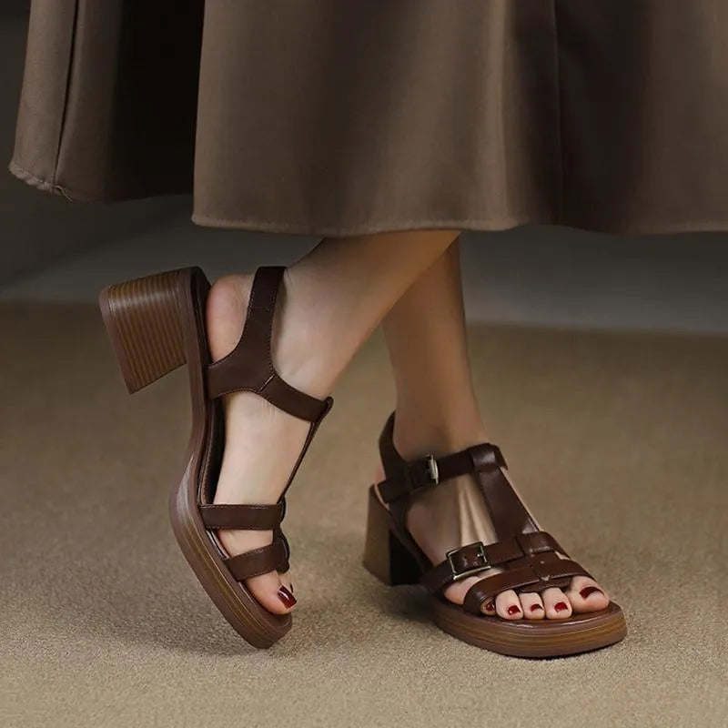Women's black retro platform sandals with chunky heel and T-buckle strap on a white background.
