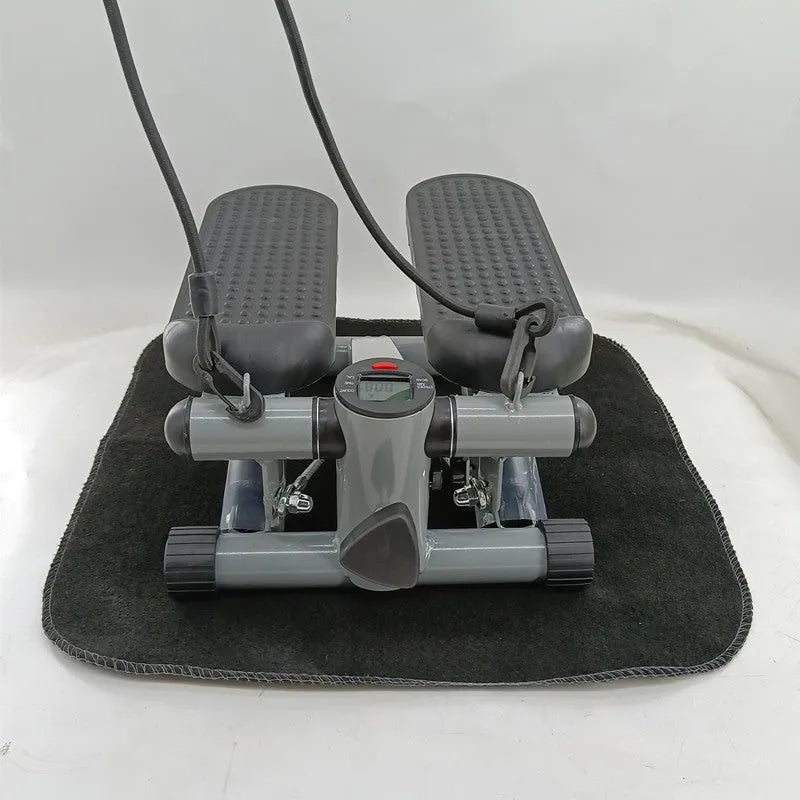 Silver grey household mini treadmill waist slimming machine with hydraulic resistance system.