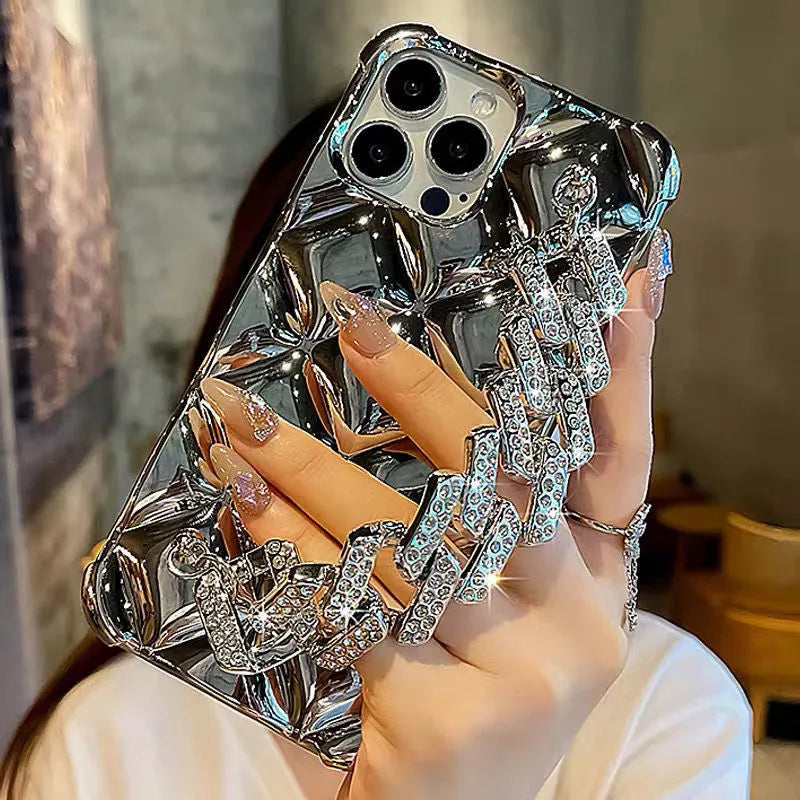 Gold diamond bracelet chain phone case for iPhone on a table.