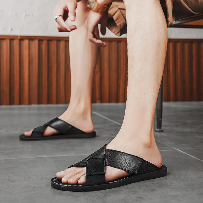 Men's black genuine pigskin leather slip-on sandals with a frosted finish and rubber sole.
