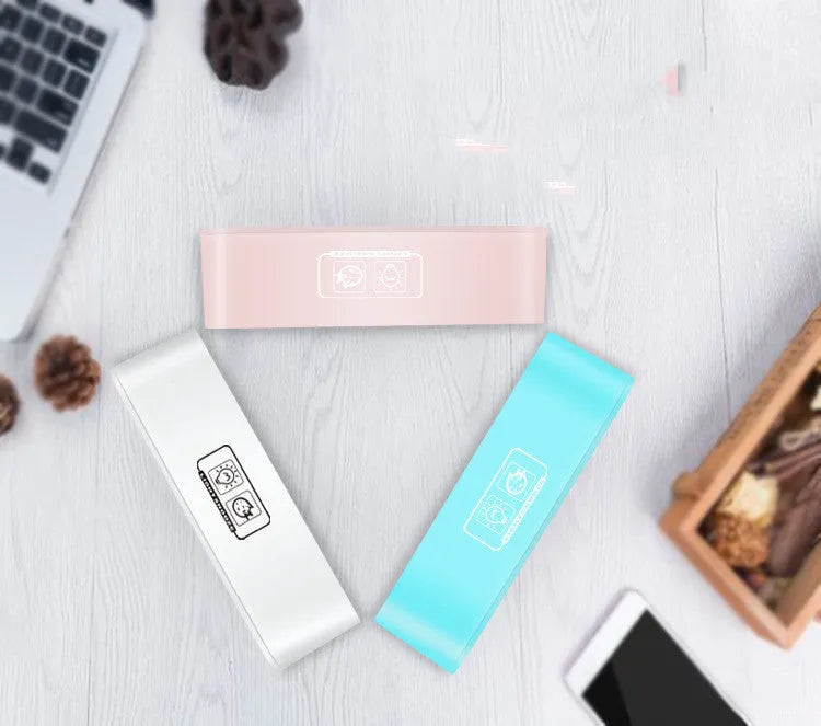 Blue rectangular LED multicoloured atmosphere light alarm clock with digital display on a desk.