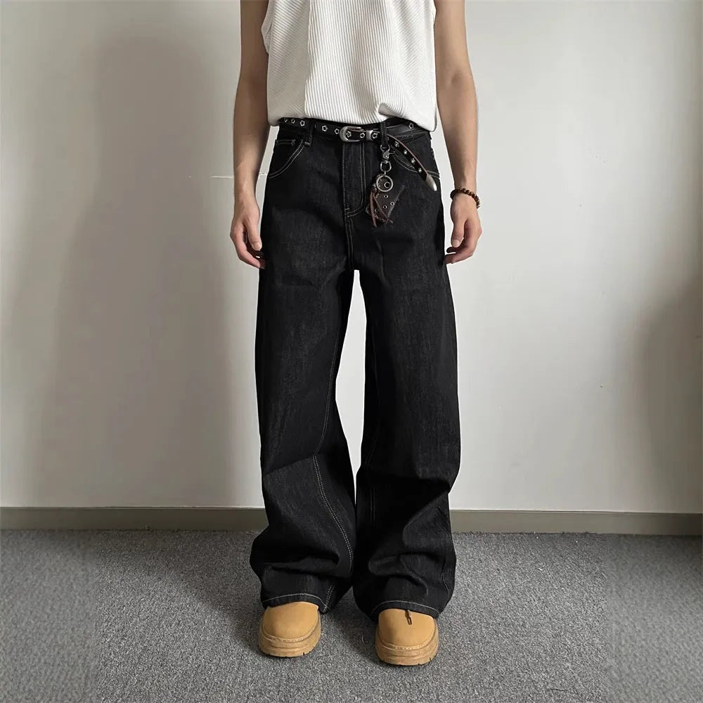 Man and woman modelling black retro wide-leg denim jeans with a straight loose fit.