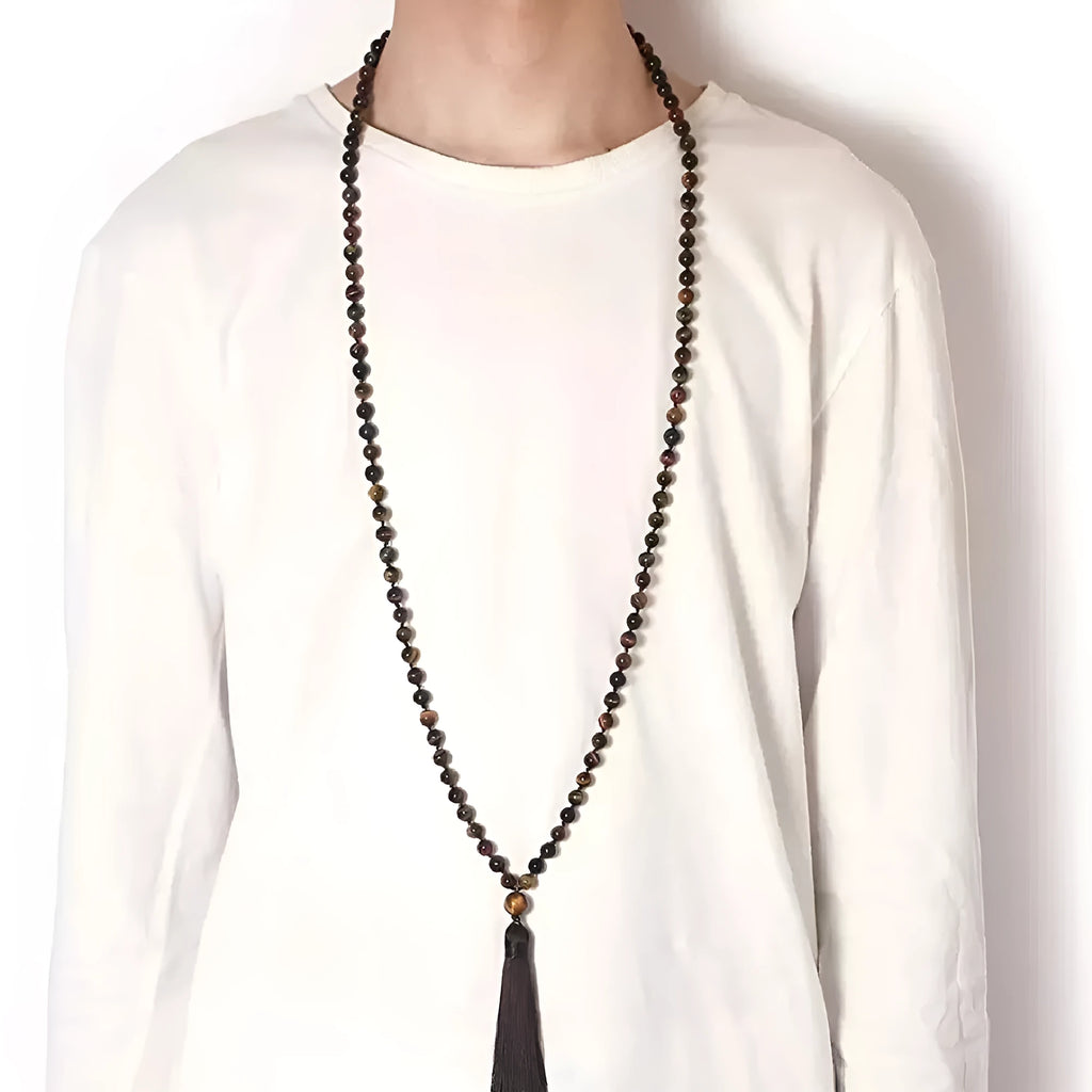 Long multicoloured agate tassel necklace with geometric beads and a flowing pendant.