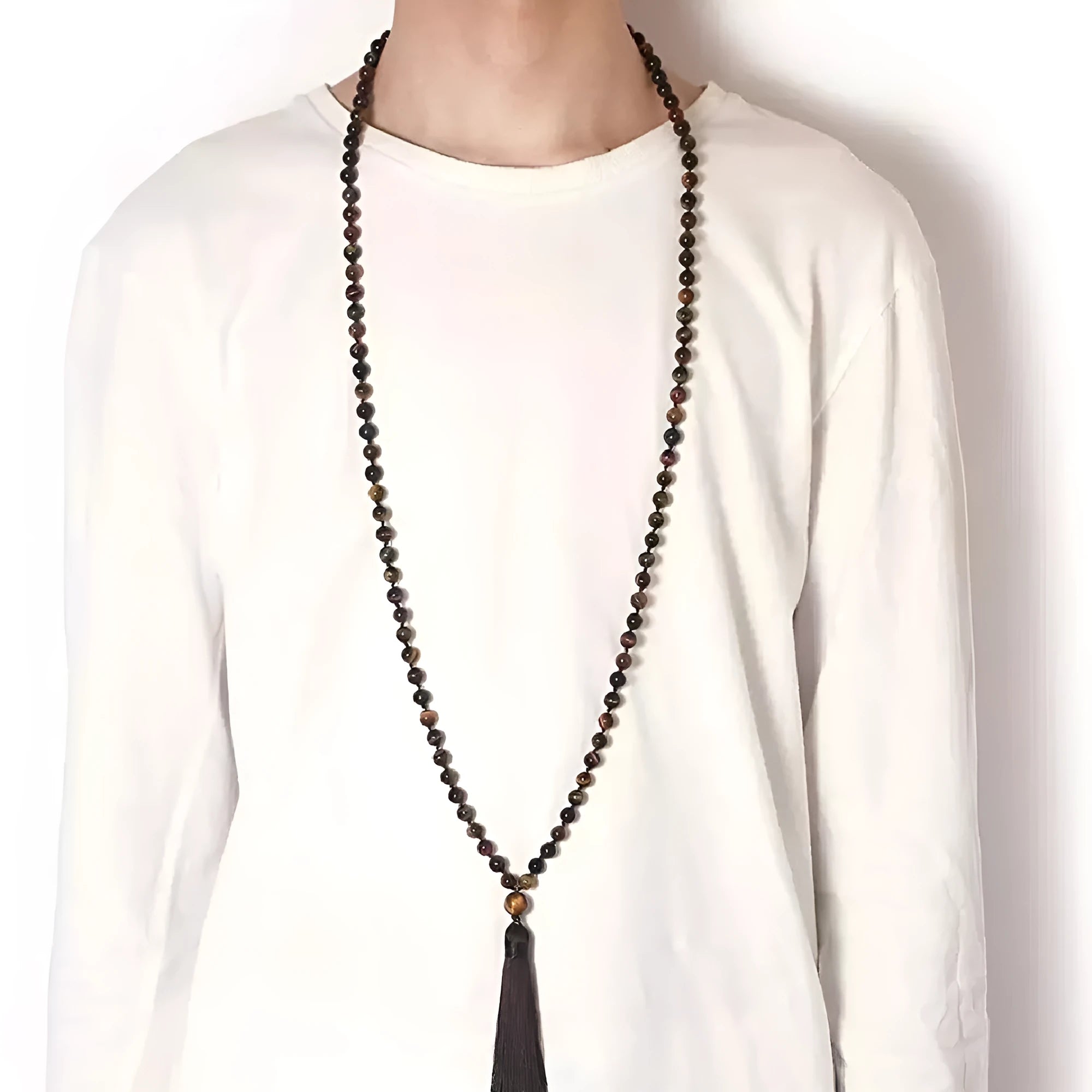 Long multicoloured agate tassel necklace with geometric beads and a flowing pendant.