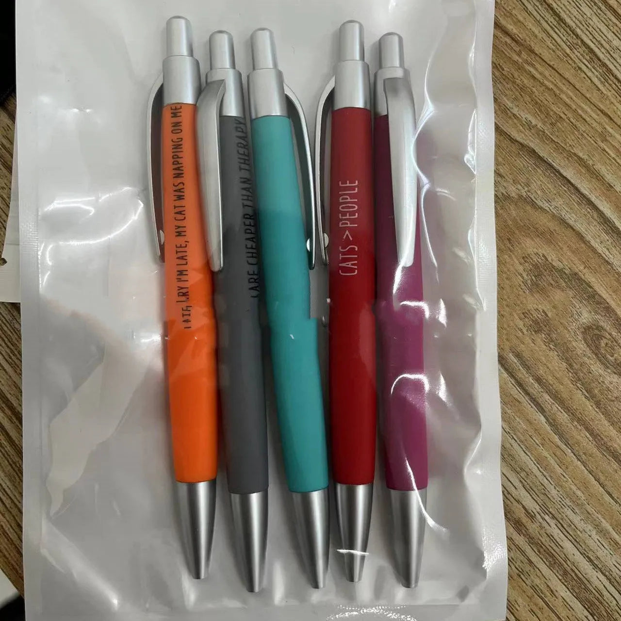 Set of five automatic push-action coloured pens in a beaded bag, with cat or dog design options.