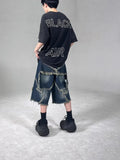 Blue American retro denim shorts with a frayed five-pointed star detail on the leg, shown in a loose fit.