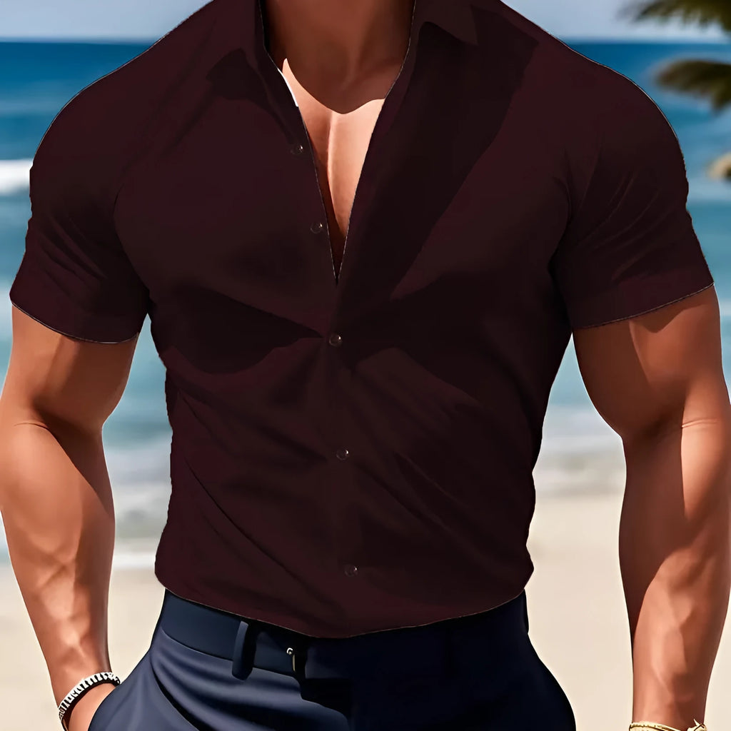 Man wearing a brown short sleeve casual printed shirt with a collar.