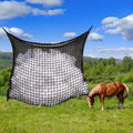 Black woven polyethylene rope hanging hay net for horses, showing the open grid pattern.